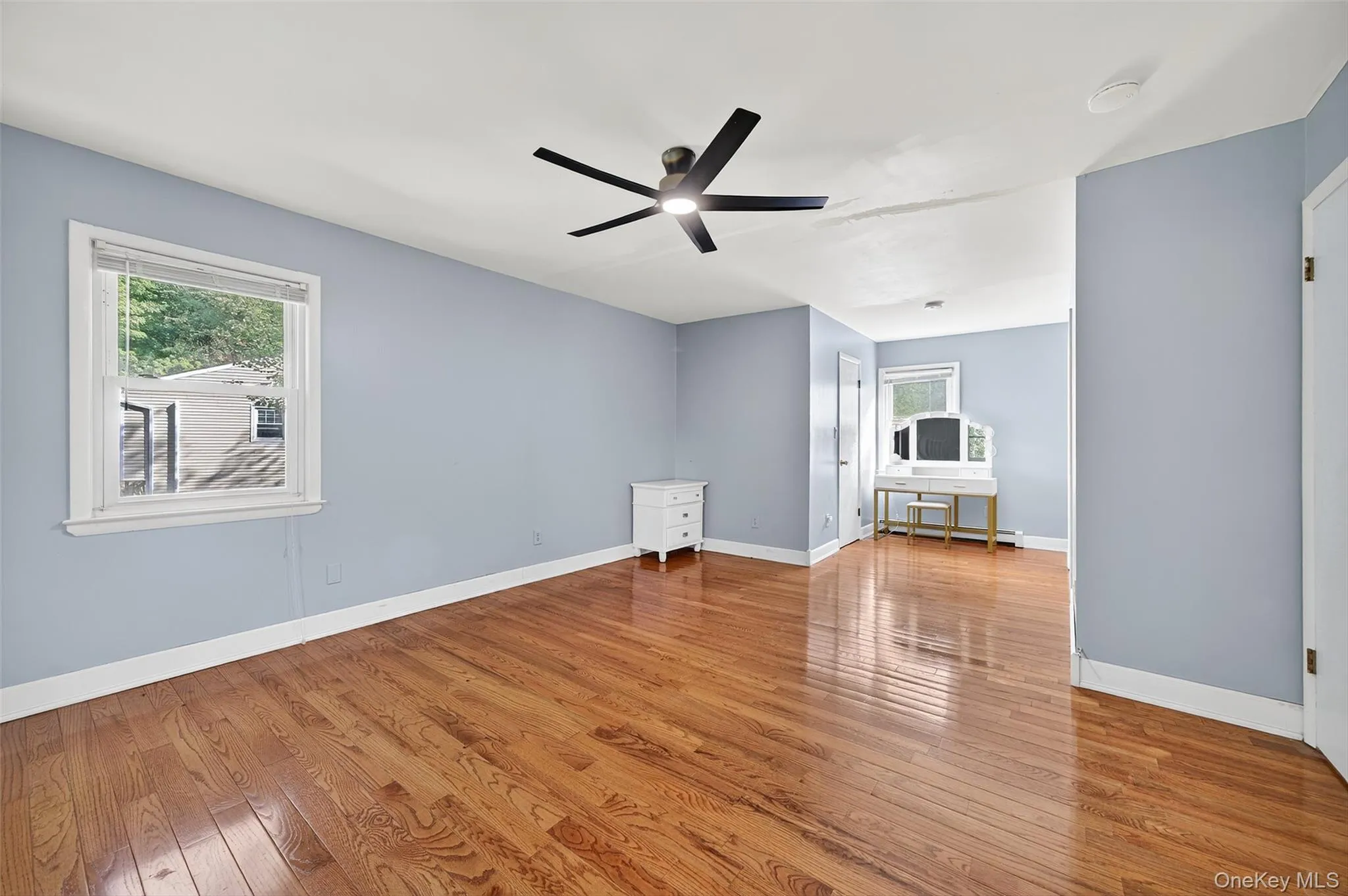 Unfurnished living room with light wood-type flooring and ceiling fan Unfurnished living room with light wood-type flooring and ceiling fan