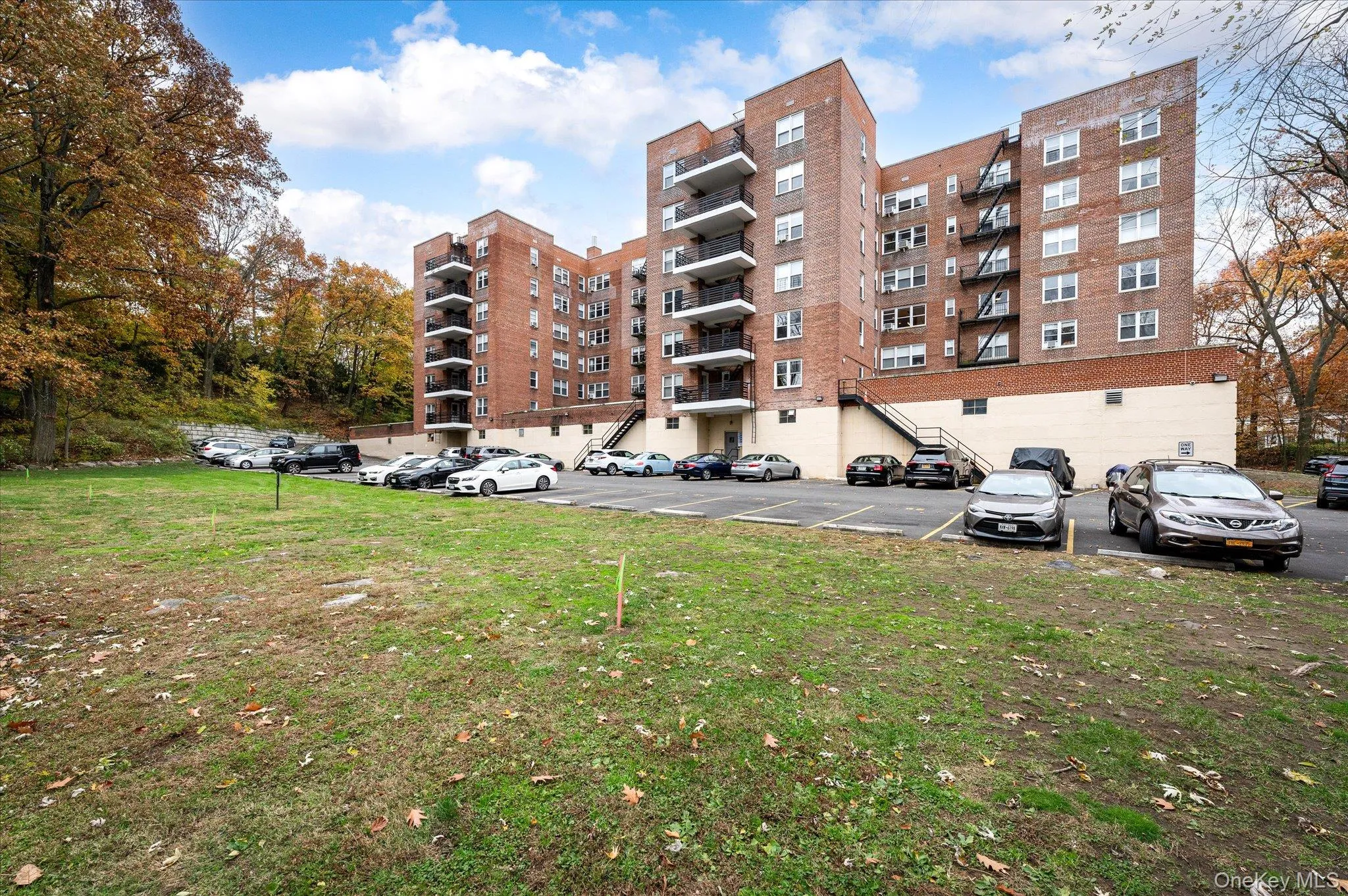 View of apartment building / complex with uncovered parking View of apartment building / complex with uncovered parking