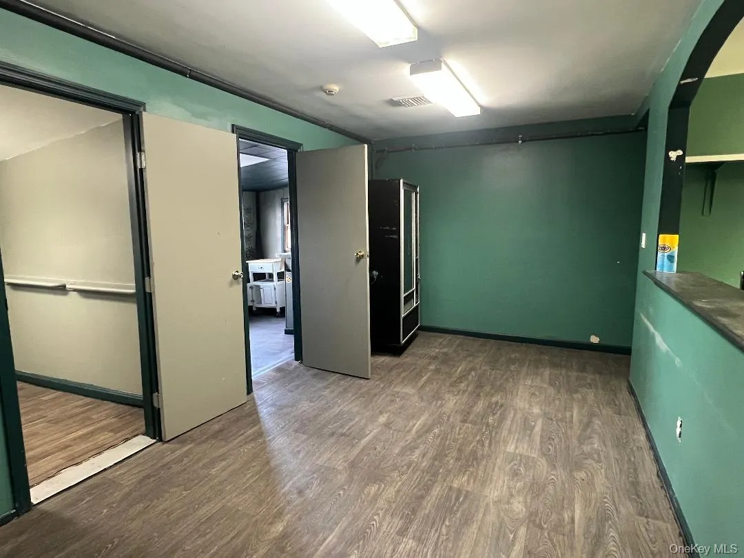 Empty room featuring dark wood-style flooring Empty room featuring dark wood-style flooring