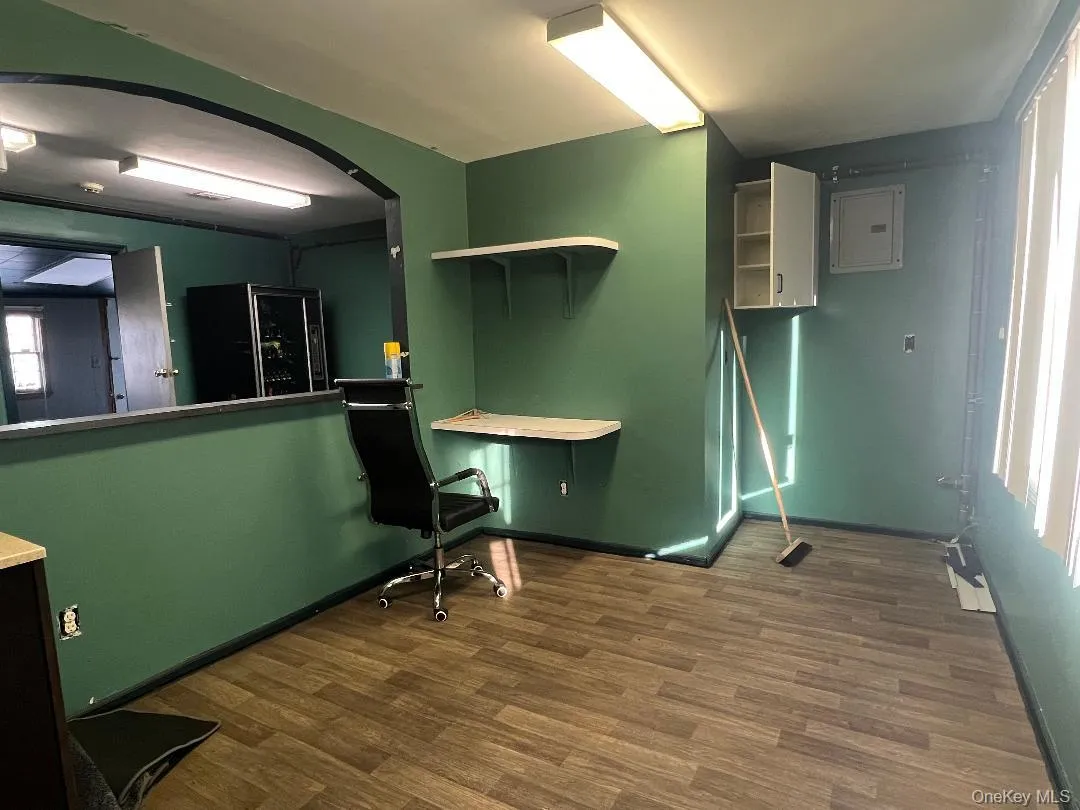 Office with electric panel and dark wood finished floors Office with electric panel and dark wood finished floors