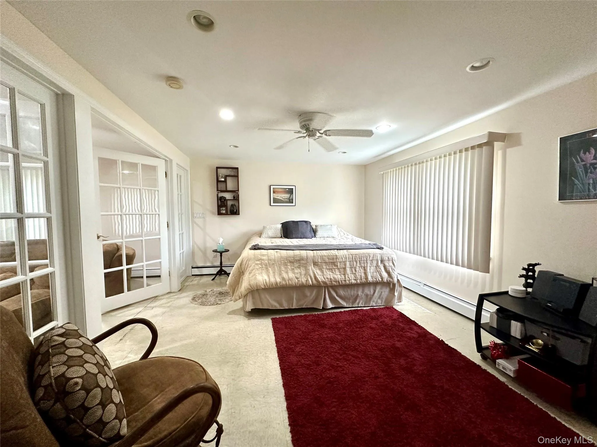 Bedroom featuring a baseboard radiator, carpet flooring, ceiling fan, and recessed lighting Bedroom featuring a baseboard radiator, carpet flooring, ceiling fan, and recessed lighting
