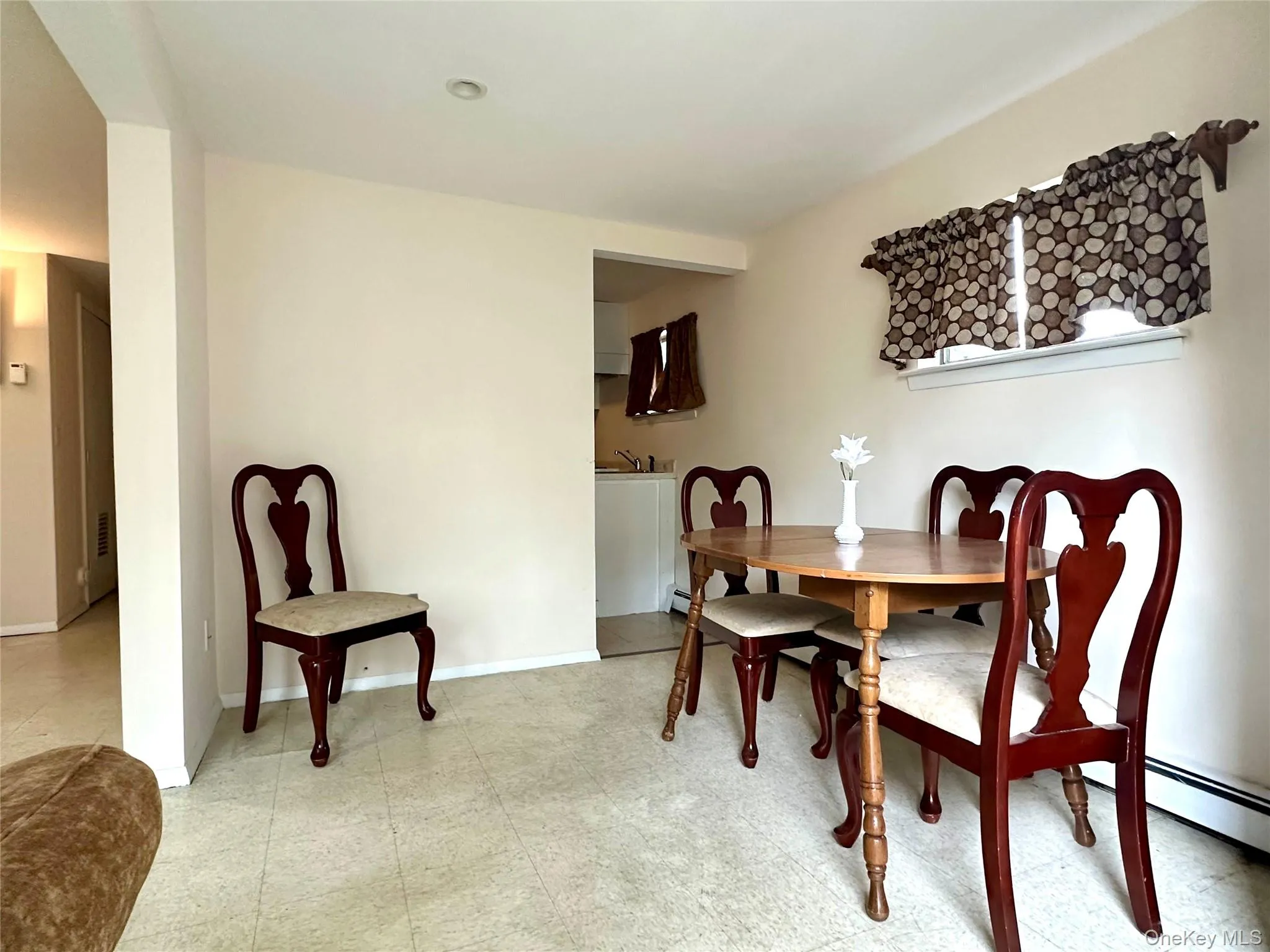 Dining area with light floors and baseboards Dining area with light floors and baseboards