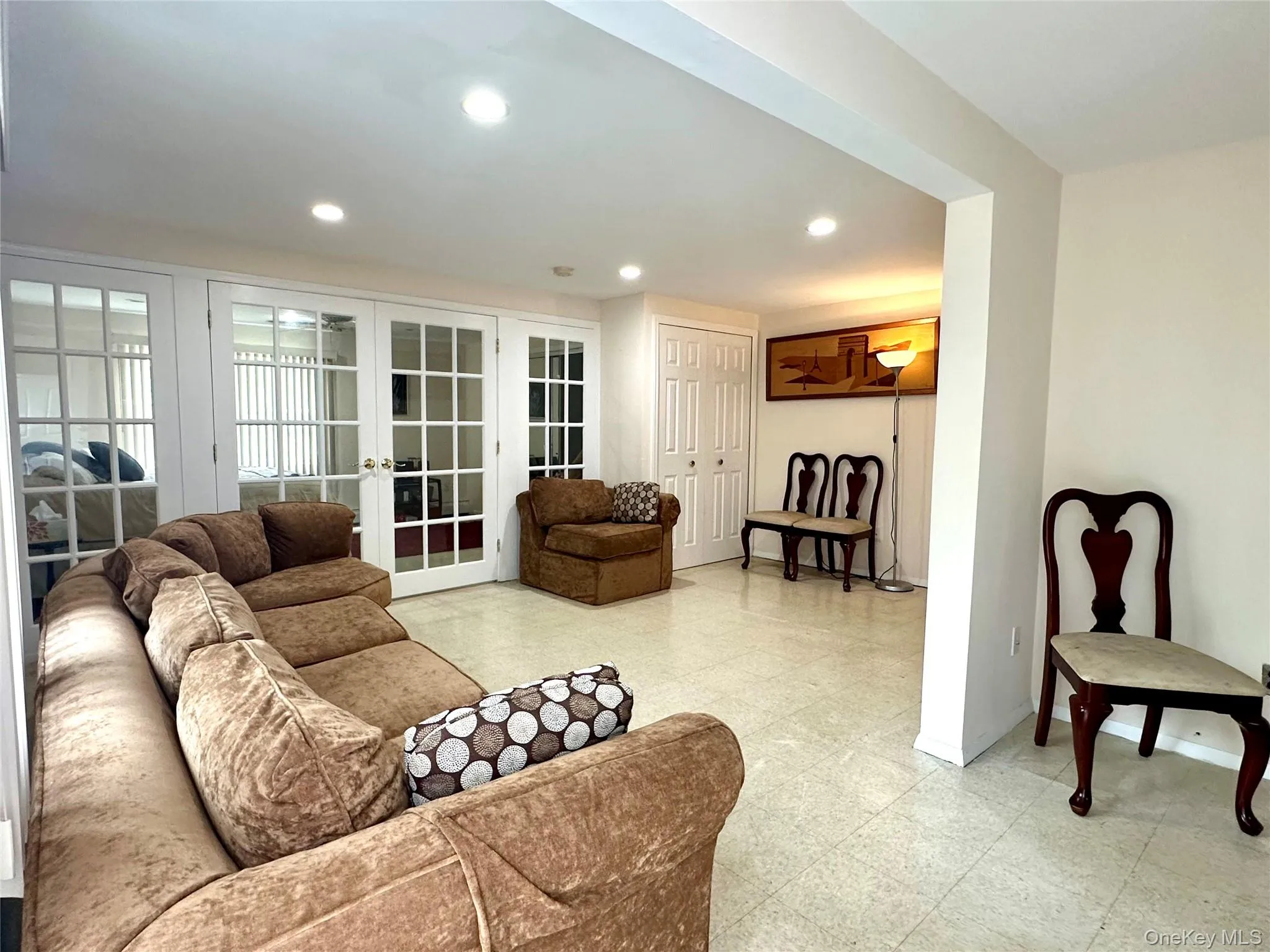 Living room with recessed lighting and light flooring Living room with recessed lighting and light flooring