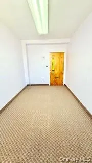 Unfurnished room with carpet and baseboards Unfurnished room with carpet and baseboards