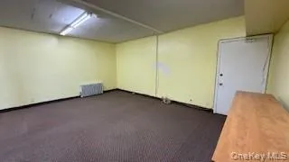 Spare room with dark carpet and radiator Spare room with dark carpet and radiator