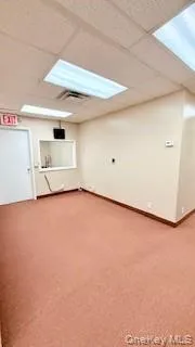 Spare room with a paneled ceiling and light colored carpet Spare room with a paneled ceiling and light colored carpet