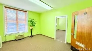 Spare room with light carpet and baseboards Spare room with light carpet and baseboards