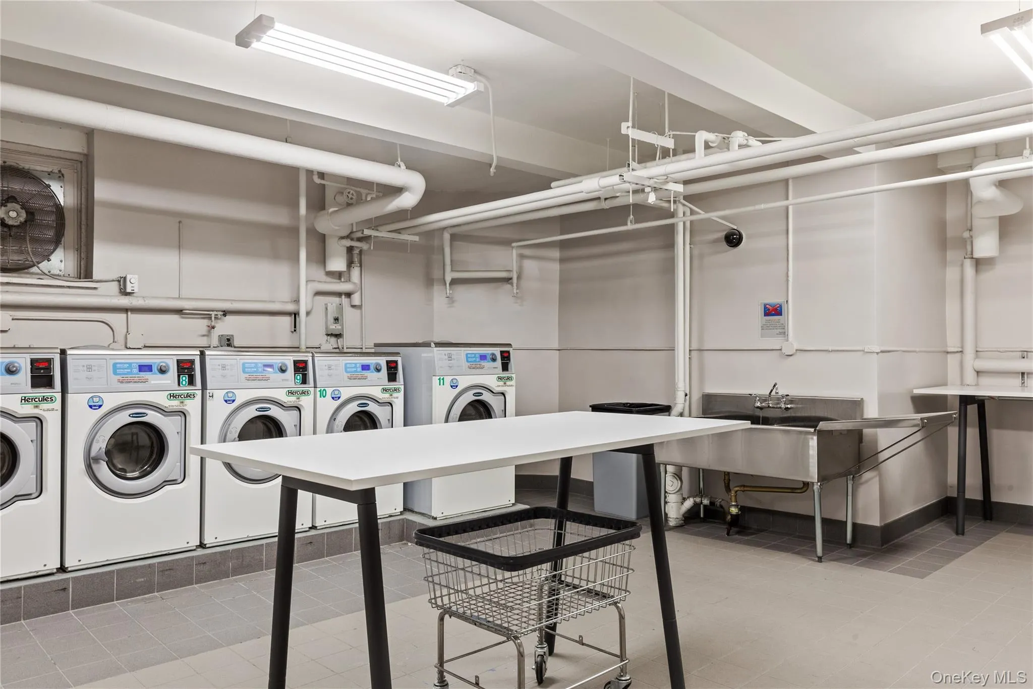 Shared laundry room with separate washer and dryer Shared laundry room with separate washer and dryer