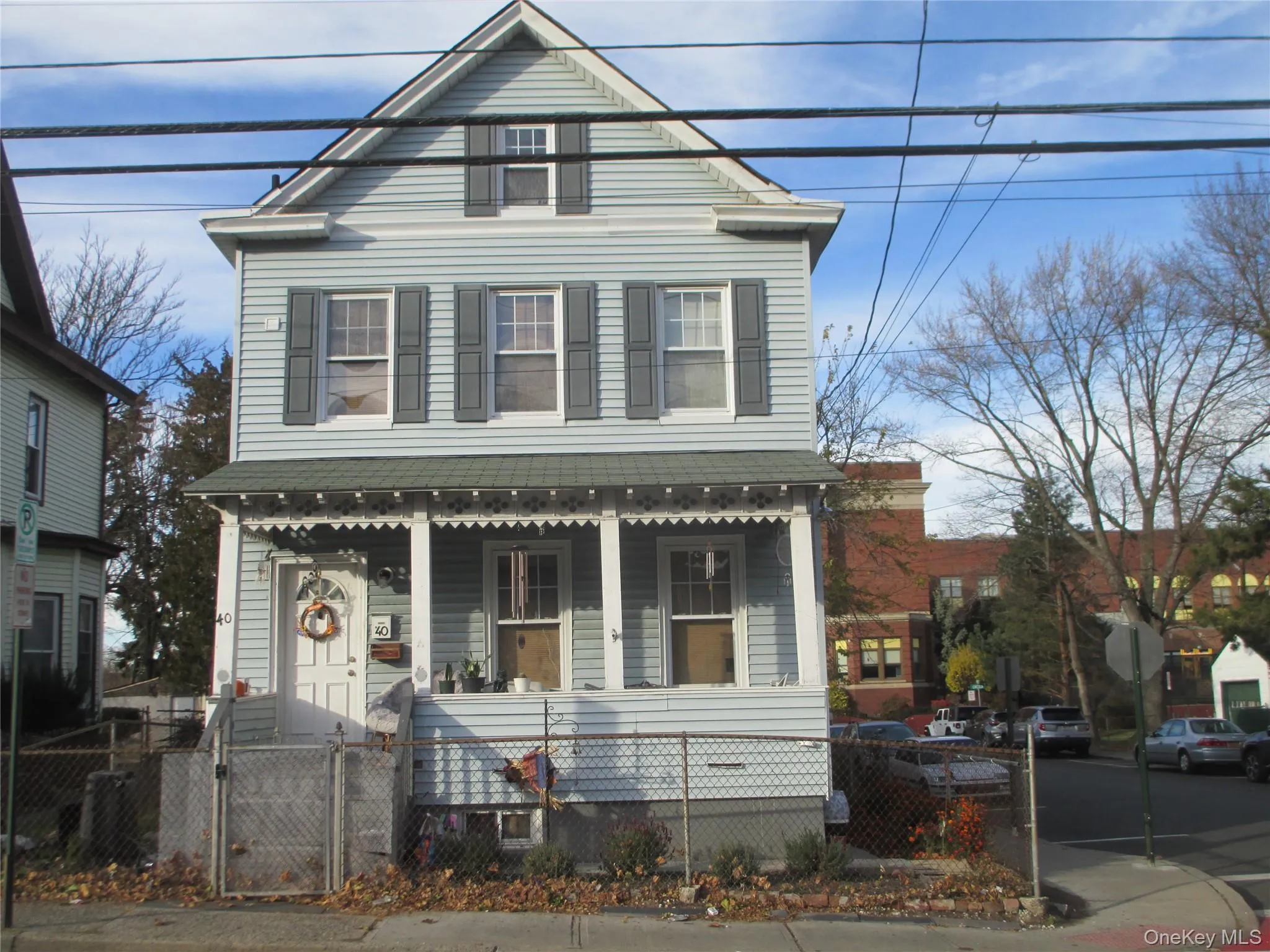 View of front of home featuring a gate, a porch, and a fenced front yard View of front of home featuring a gate, a porch, and a fenced front yard