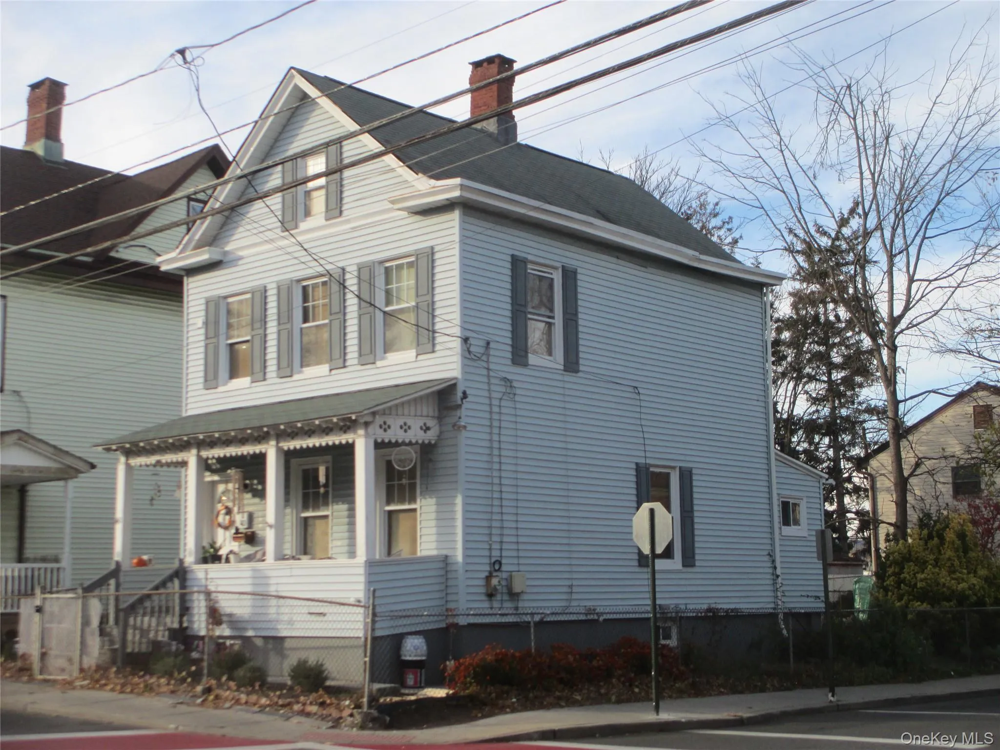 View of property exterior with a chimney and a porch View of property exterior with a chimney and a porch