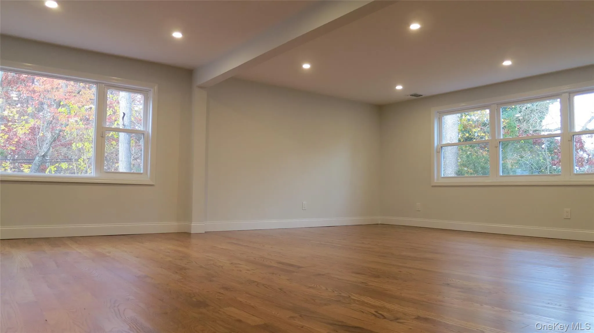 Spare room with light wood-style flooring, recessed lighting, and beamed ceiling Spare room with light wood-style flooring, recessed lighting, and beamed ceiling