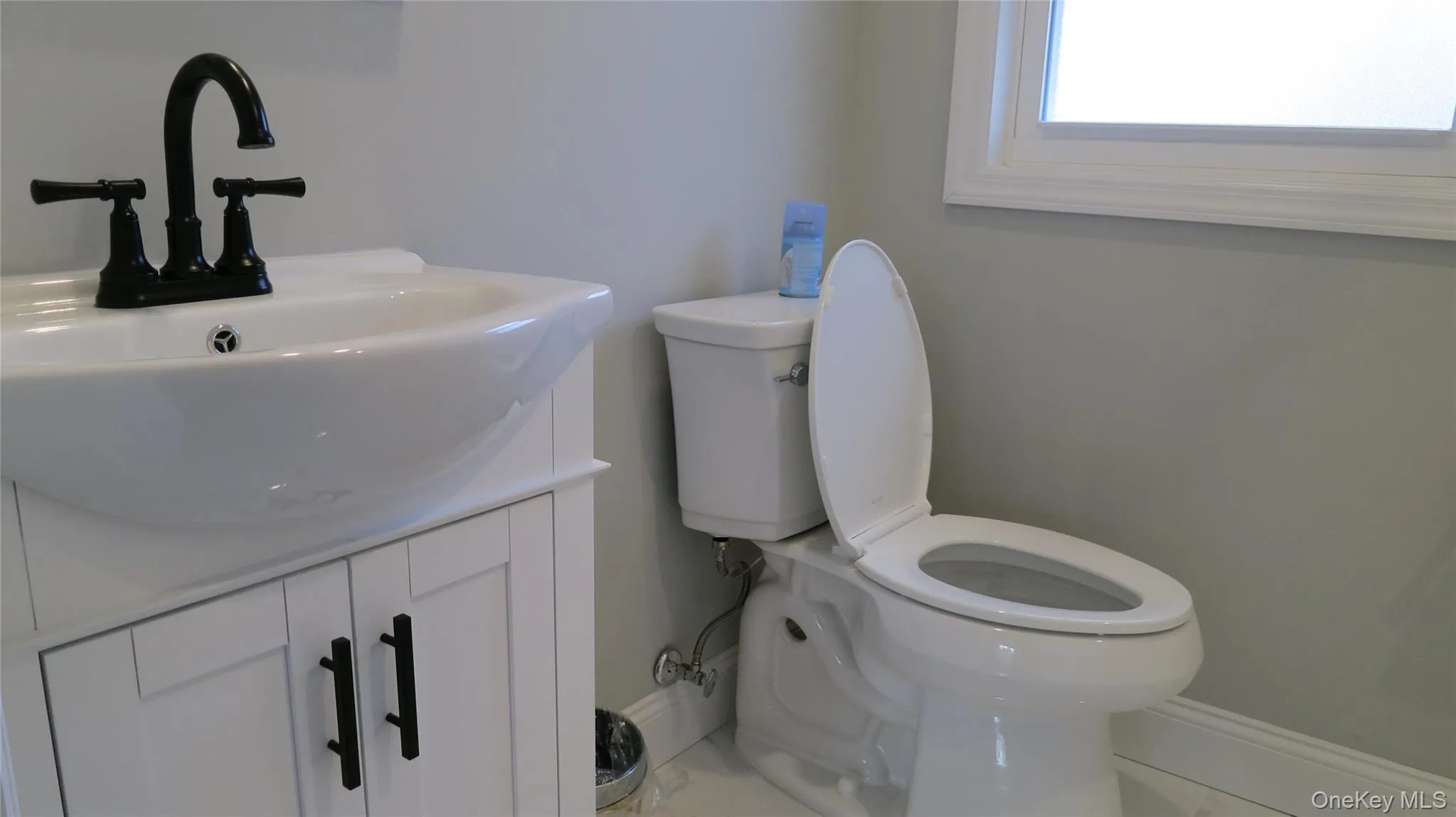 Half bath with vanity and toilet Half bath with vanity and toilet