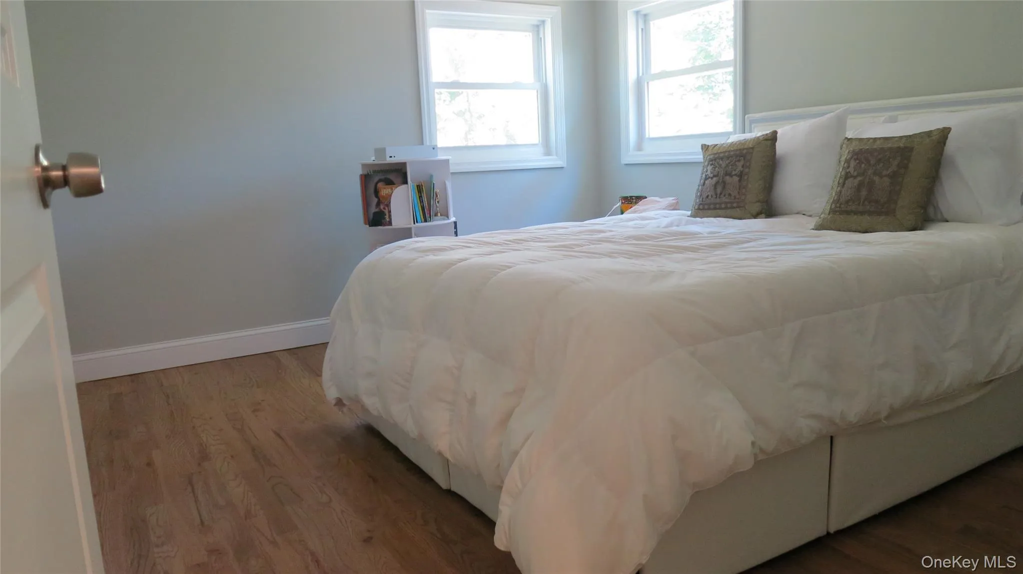Bedroom with wood finished floors and baseboards Bedroom with wood finished floors and baseboards