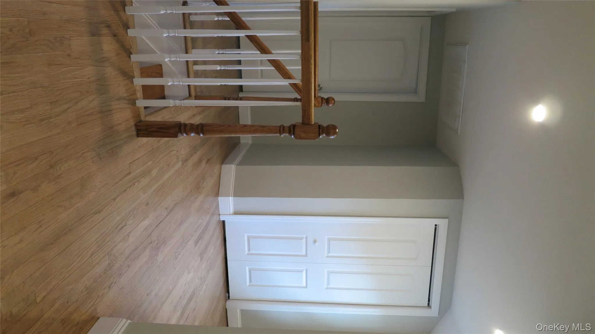 Hall with light wood-style flooring, recessed lighting, and an upstairs landing Hall with light wood-style flooring, recessed lighting, and an upstairs landing