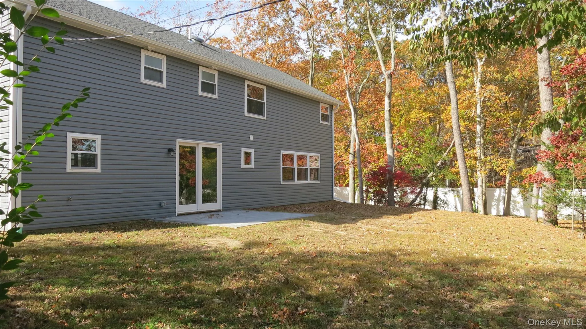Back of property with a patio and a shingled roof Back of property with a patio and a shingled roof