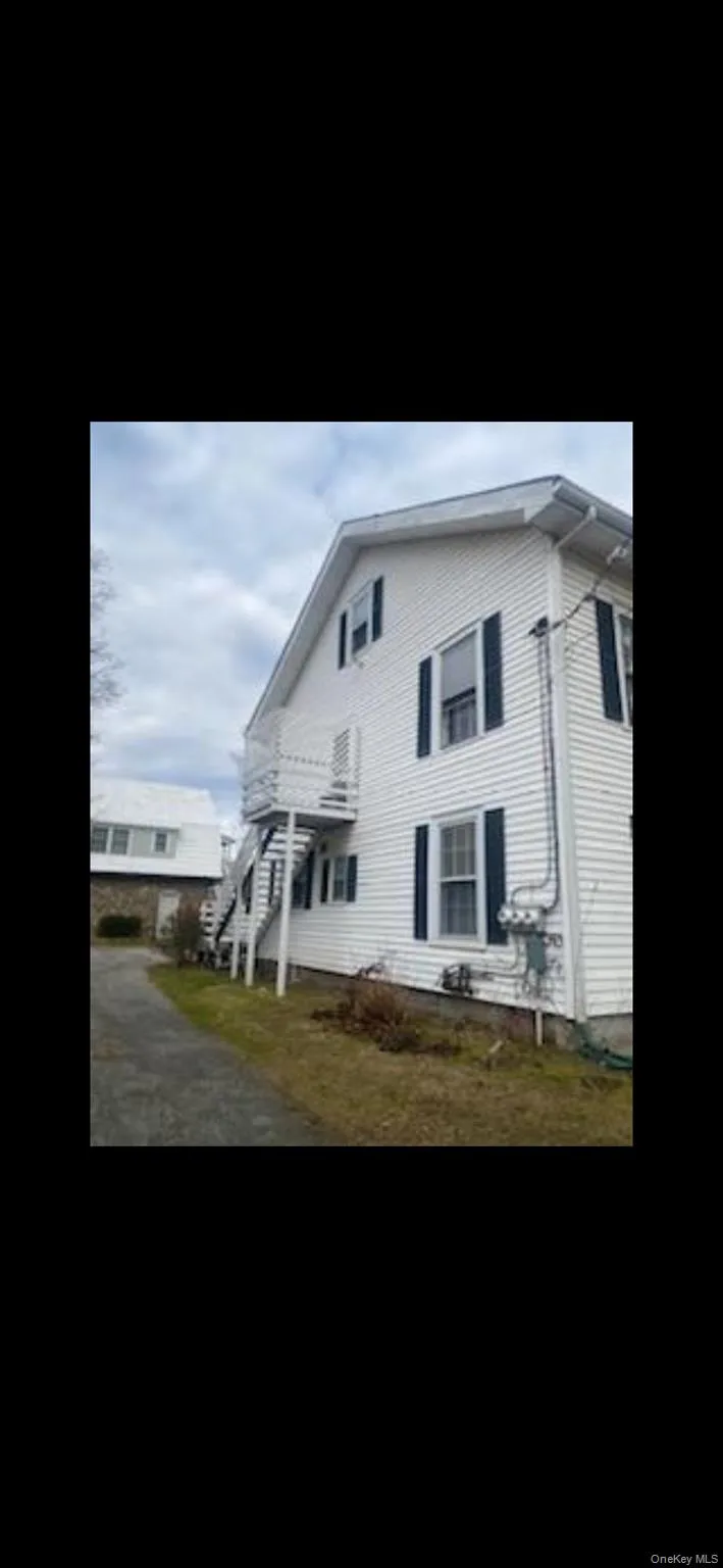 View of home's exterior featuring stairs and a lawn View of home's exterior featuring stairs and a lawn