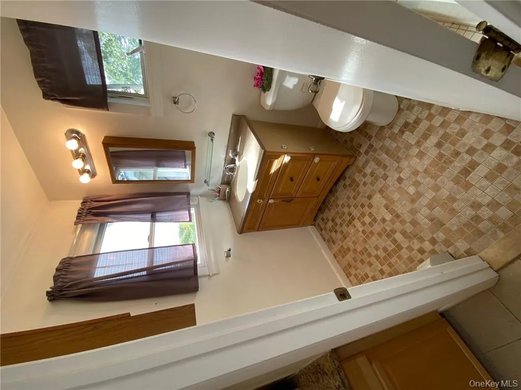 Bathroom featuring vanity and toilet Bathroom featuring vanity and toilet