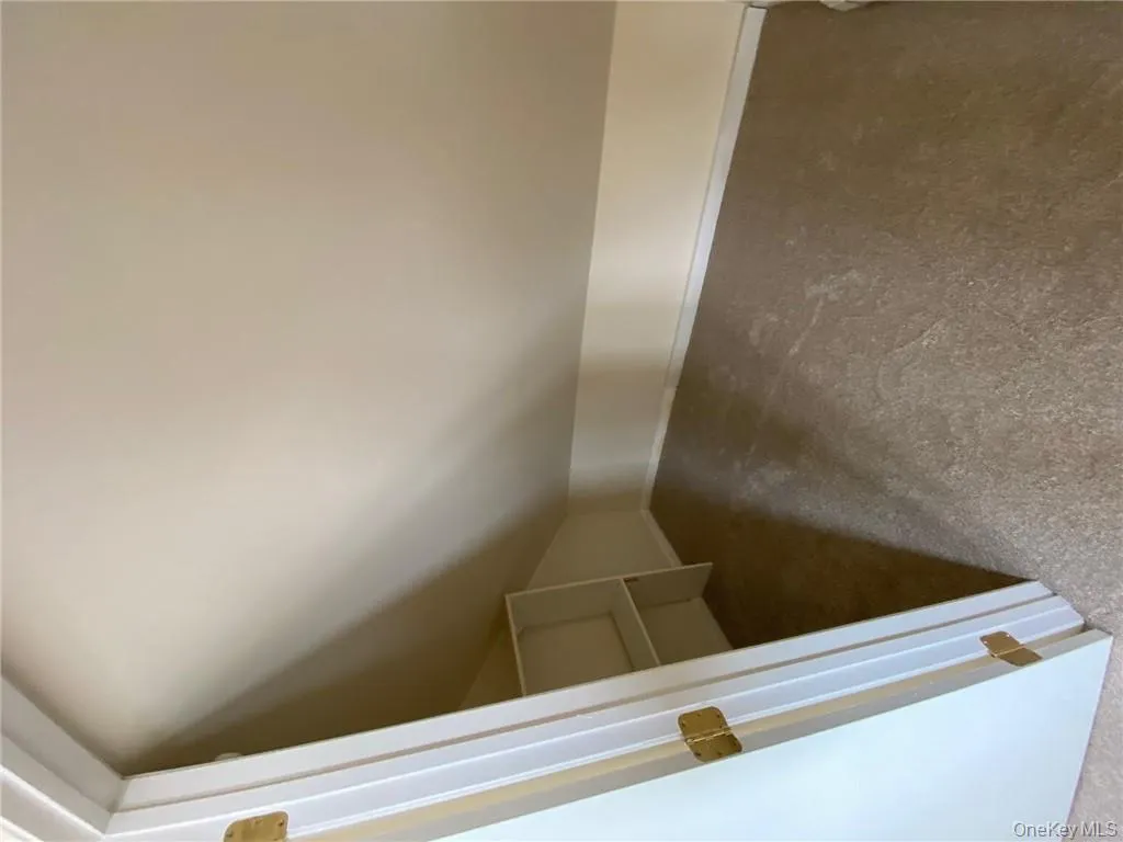 Additional living space featuring dark carpet and lofted ceiling Additional living space featuring dark carpet and lofted ceiling