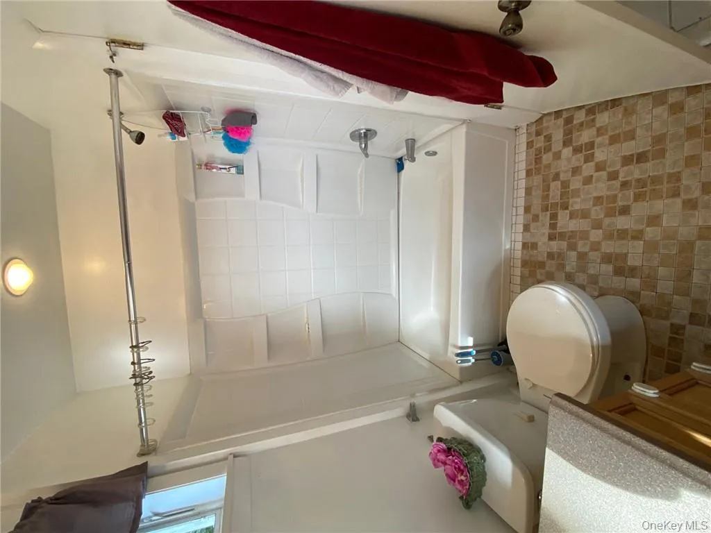Full bathroom with bathing tub / shower combination, vanity, and toilet Full bathroom with bathing tub / shower combination, vanity, and toilet