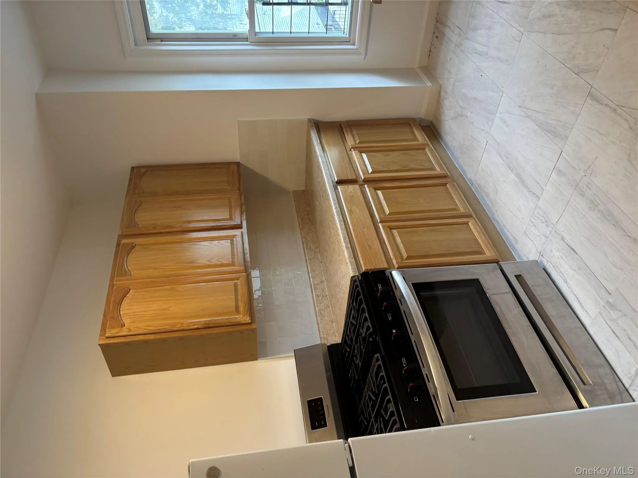 Kitchen with range, tasteful backsplash, fridge, and brown cabinets Kitchen with range, tasteful backsplash, fridge, and brown cabinets