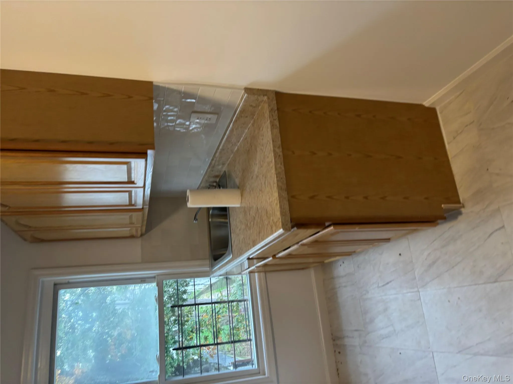 Kitchen with light countertops and tasteful backsplash Kitchen with light countertops and tasteful backsplash
