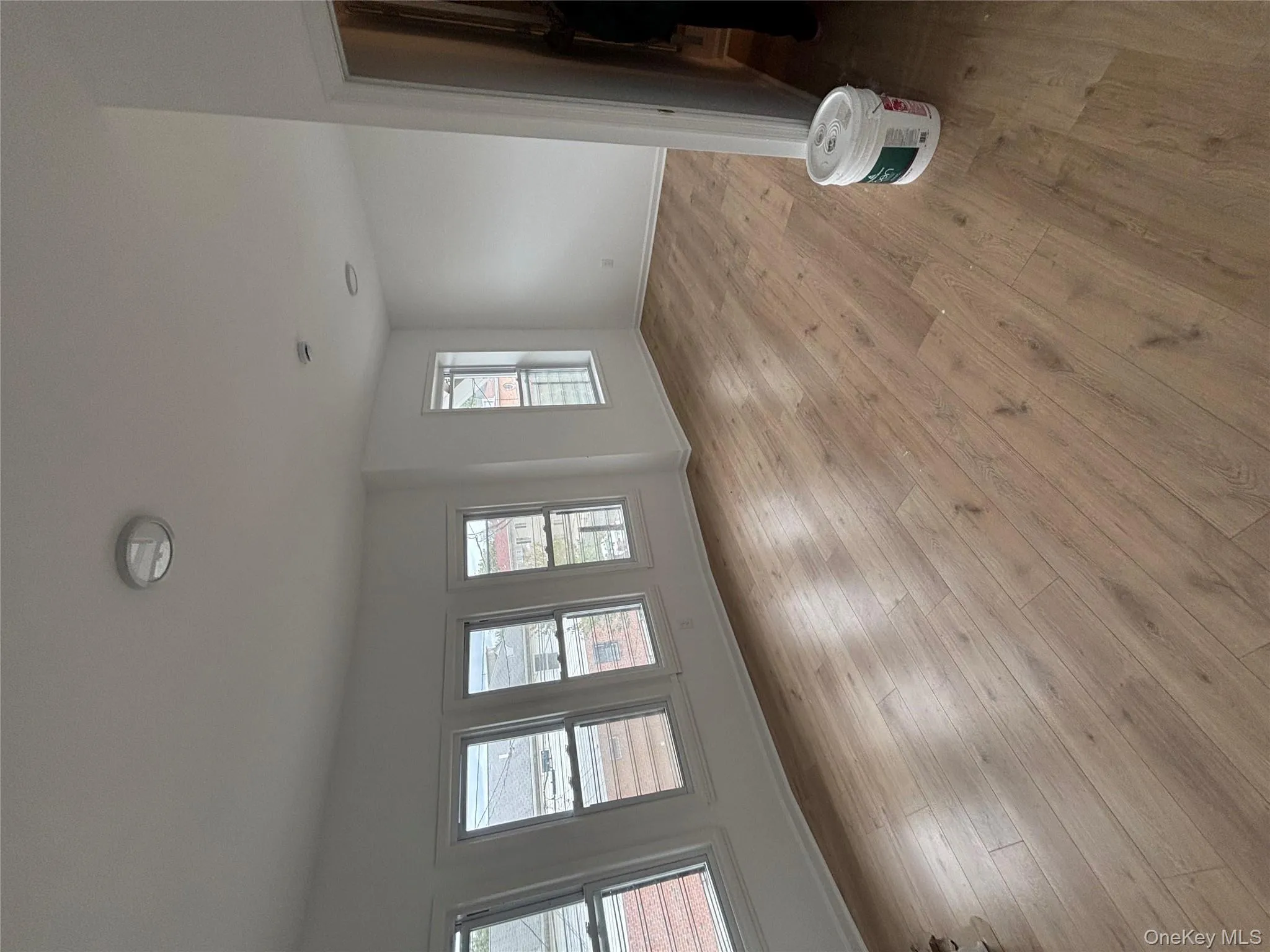 Unfurnished living room featuring baseboards and light wood-style floors Unfurnished living room featuring baseboards and light wood-style floors