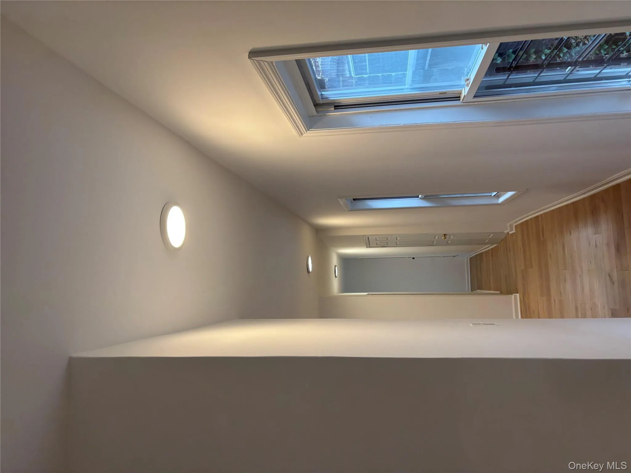 Hallway with light wood finished floors and baseboards Hallway with light wood finished floors and baseboards