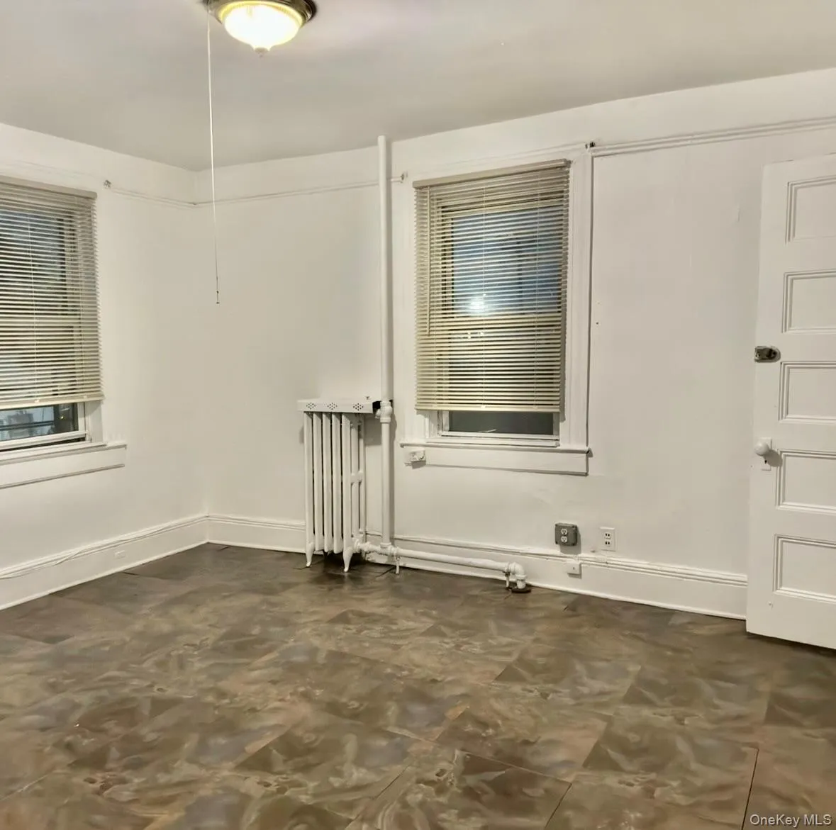 Empty room with radiator and baseboards Empty room with radiator and baseboards