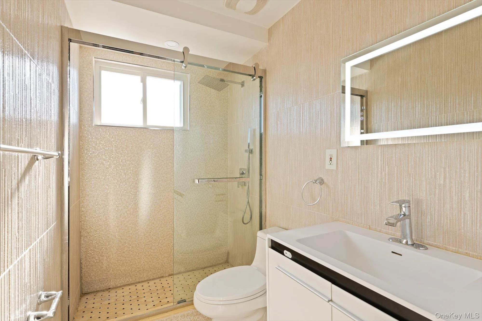 Full bathroom featuring vanity, a stall shower, and tile walls Full bathroom featuring vanity, a stall shower, and tile walls
