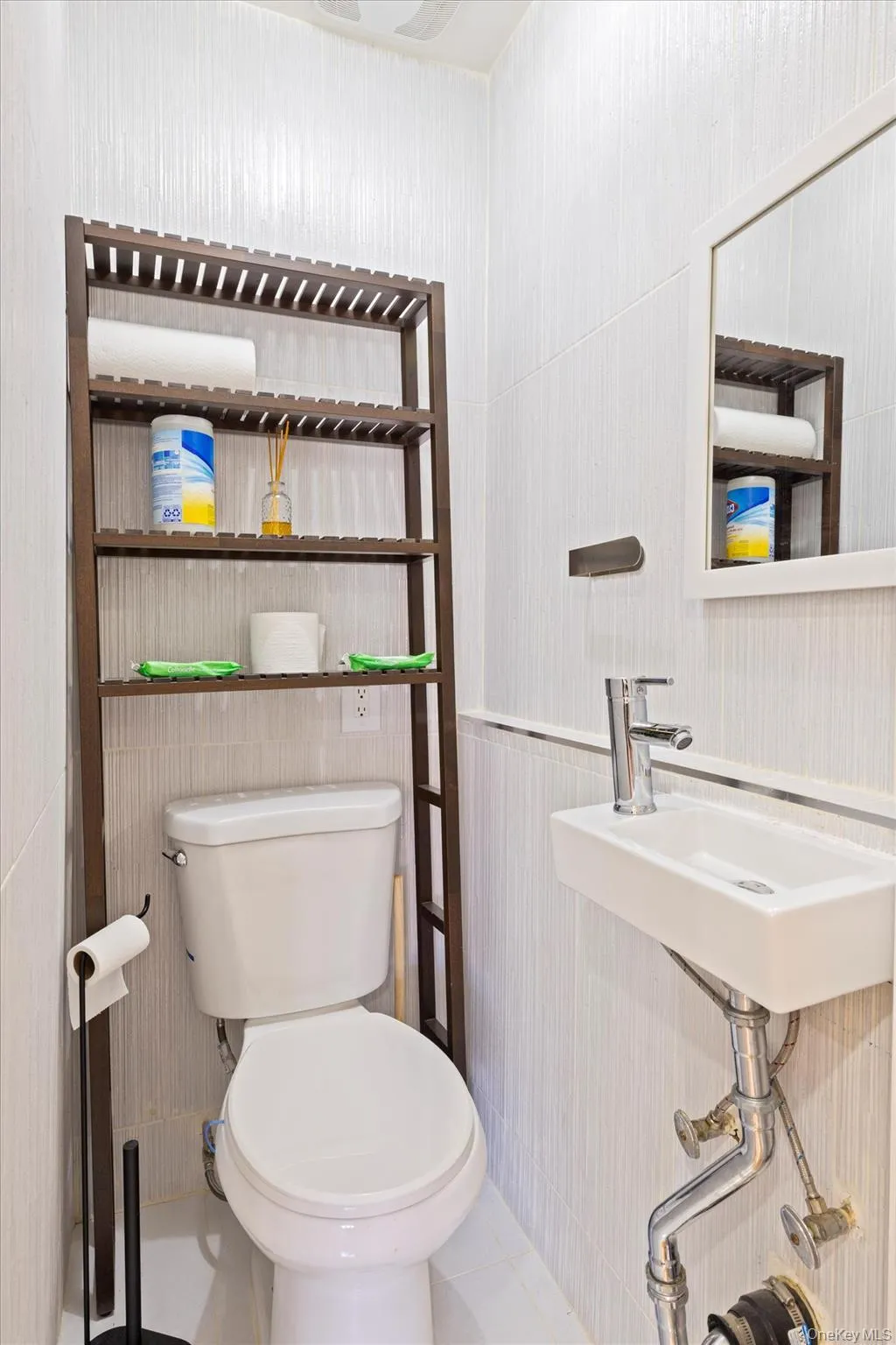 Bathroom featuring toilet and a sink Bathroom featuring toilet and a sink
