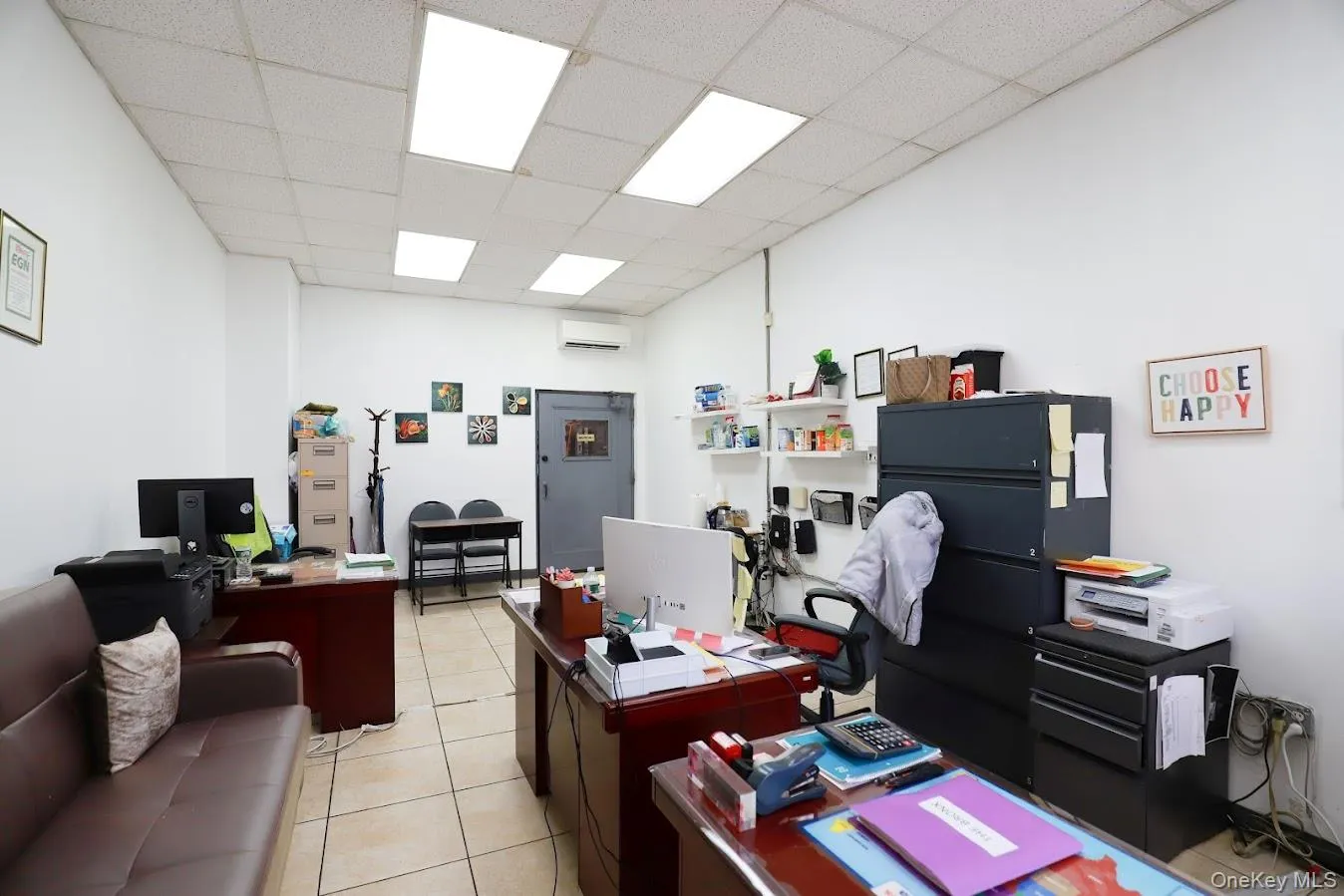 Office featuring a paneled ceiling and a wall mounted AC Office featuring a paneled ceiling and a wall mounted AC