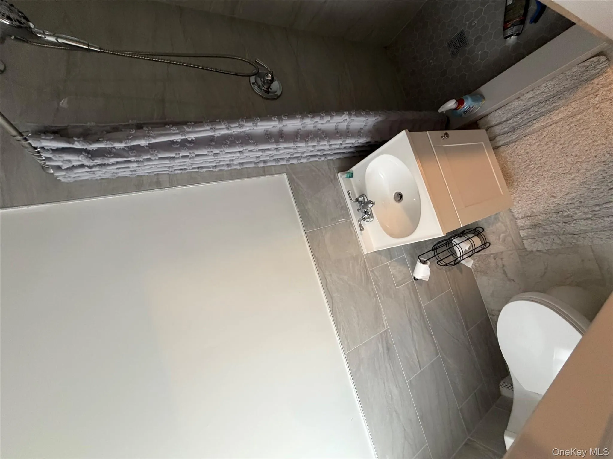 Full bathroom featuring a stall shower, vanity, and tile walls Full bathroom featuring a stall shower, vanity, and tile walls
