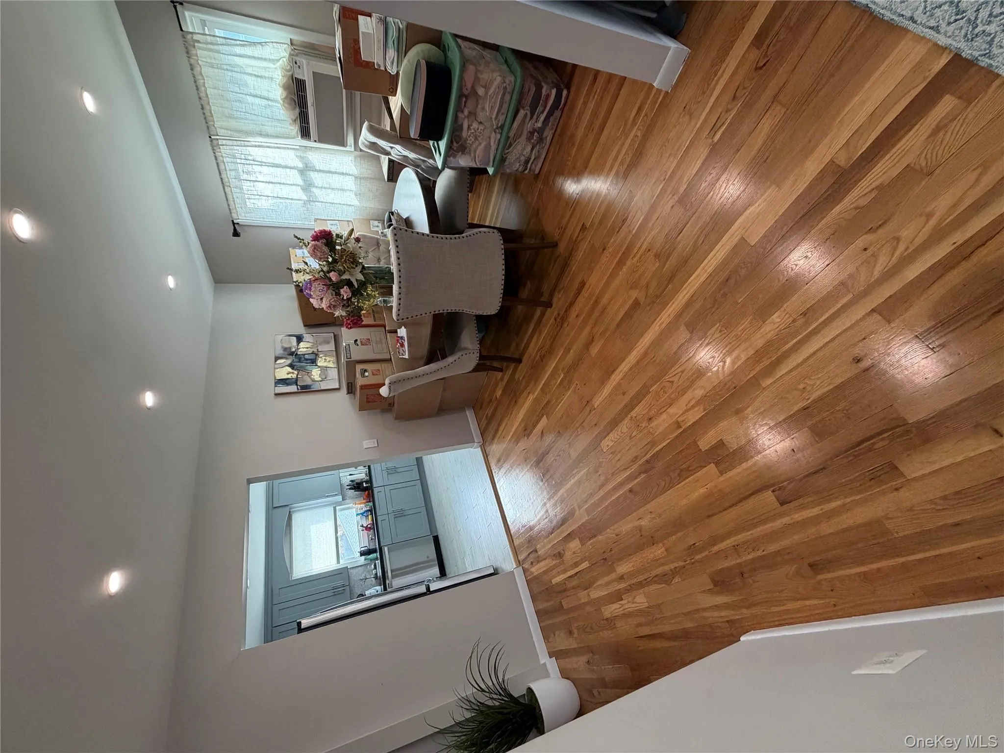 Dining area with light wood flooring, recessed lighting, and cooling unit Dining area with light wood flooring, recessed lighting, and cooling unit