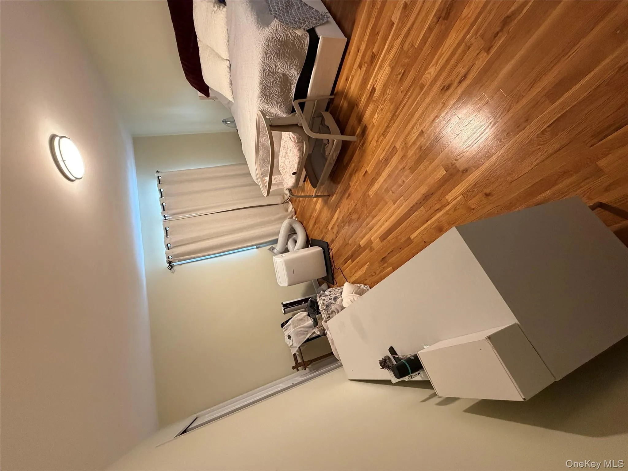 Bedroom featuring wood flooring Bedroom featuring wood flooring