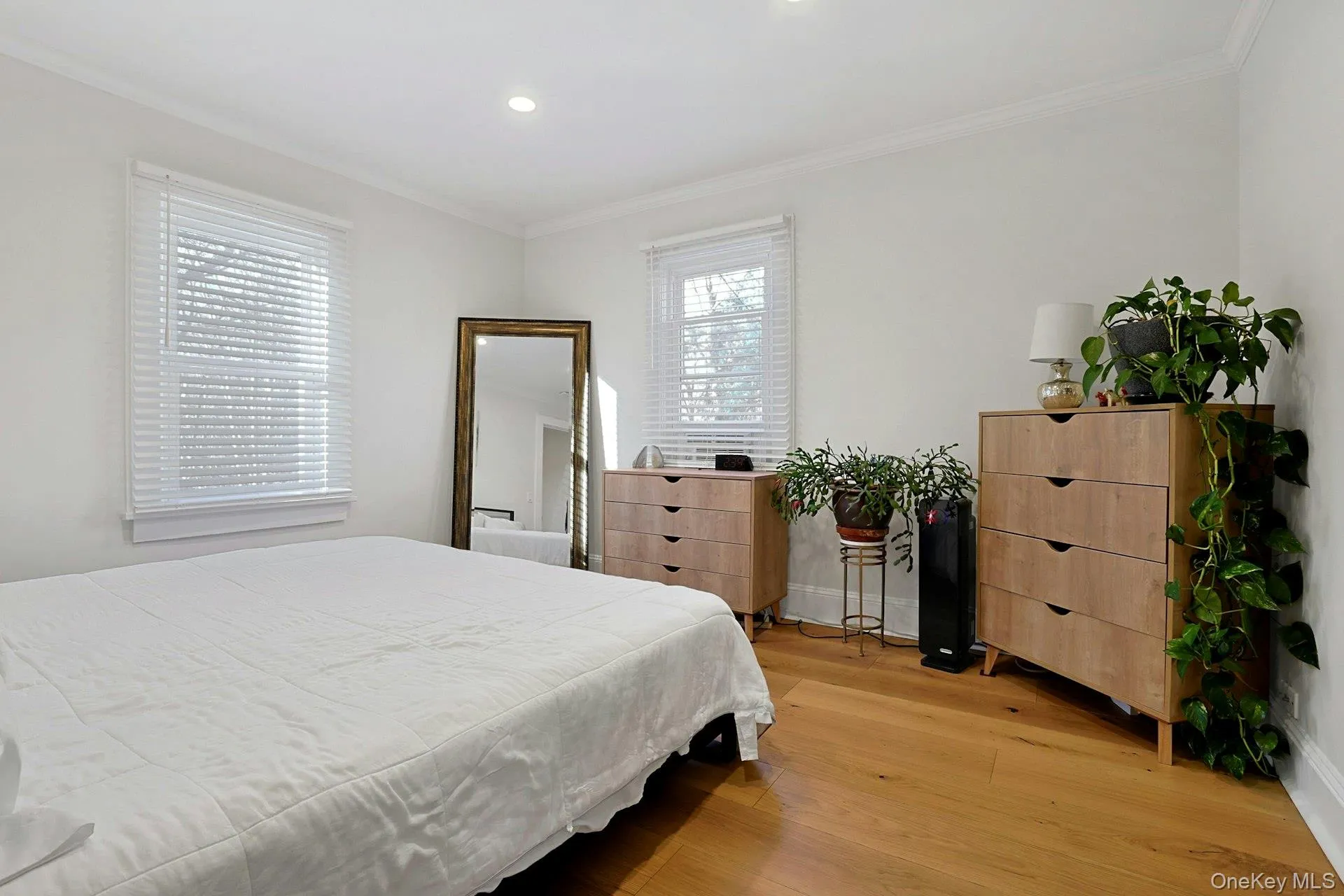Bedroom with king size bed, crown molding, light wood-style flooring, and recessed lighting Bedroom with king size bed, crown molding, light wood-style flooring, and recessed lighting