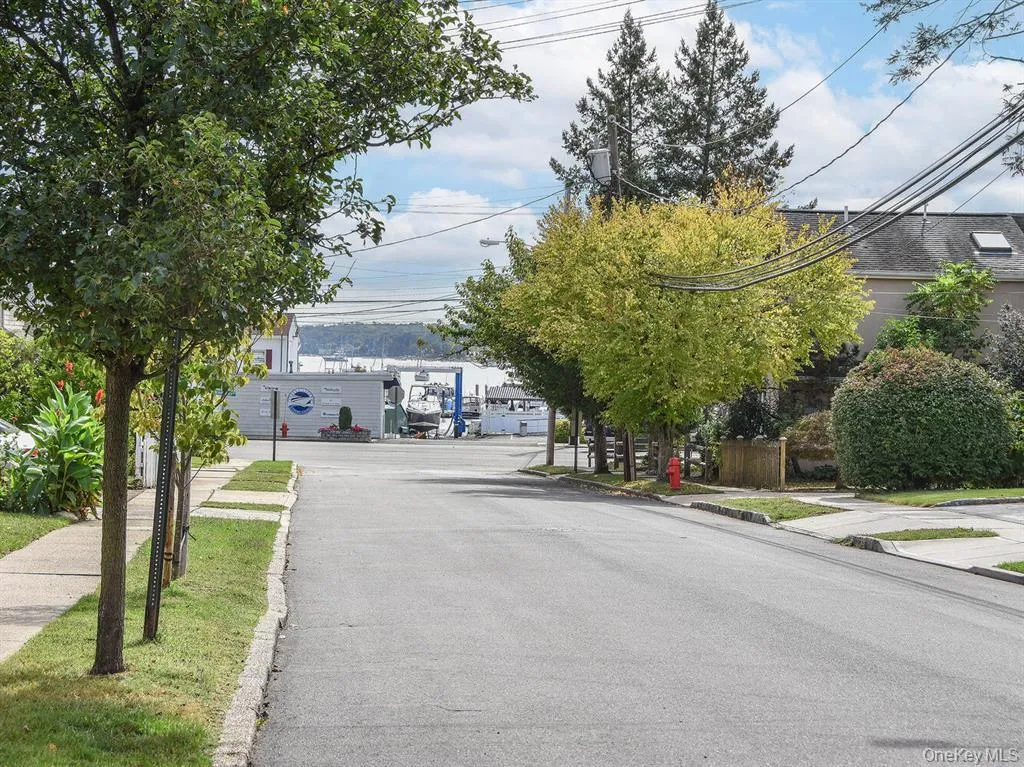 View of asphalt road featuring sidewalks and curbs View of asphalt road featuring sidewalks and curbs