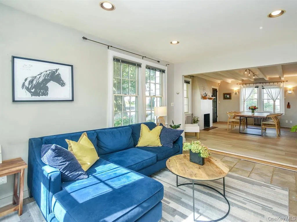 Living room featuring recessed lighting, wood finished floors, and beam ceiling Living room featuring recessed lighting, wood finished floors, and beam ceiling