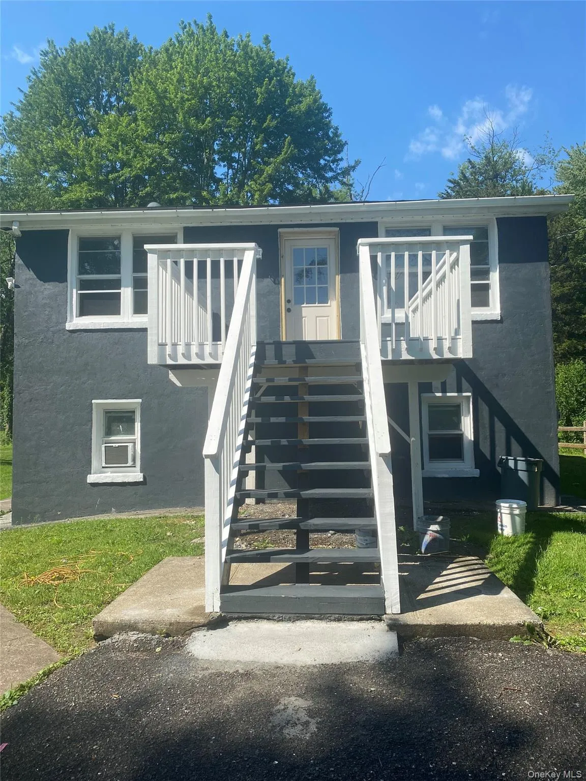 View of front of house featuring stairway and stucco siding View of front of house featuring stairway and stucco siding