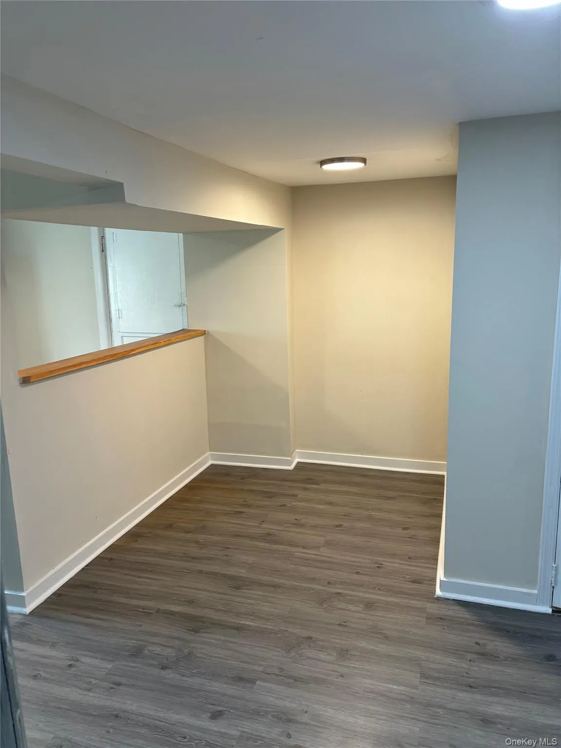 Spare room with dark wood finished floors and baseboards Spare room with dark wood finished floors and baseboards