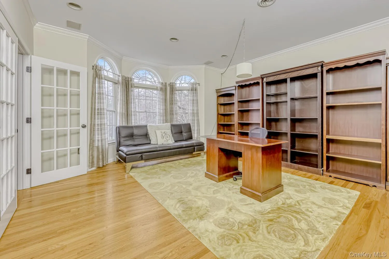Office area with crown molding and light wood finished floors Office area with crown molding and light wood finished floors