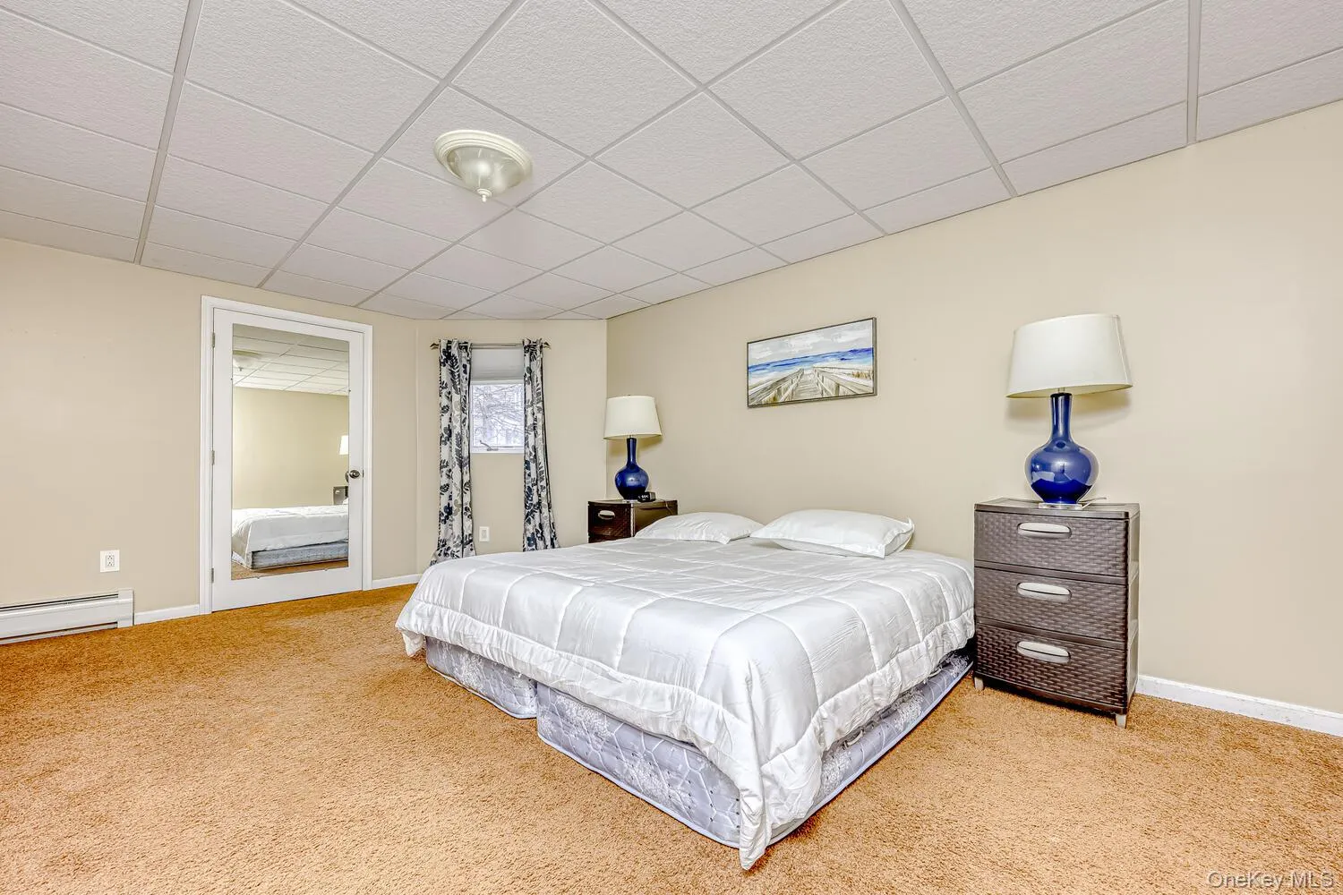 Carpeted bedroom with a drop ceiling Carpeted bedroom with a drop ceiling