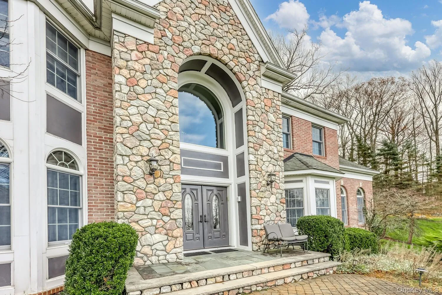 Doorway to property featuring stone siding Doorway to property featuring stone siding