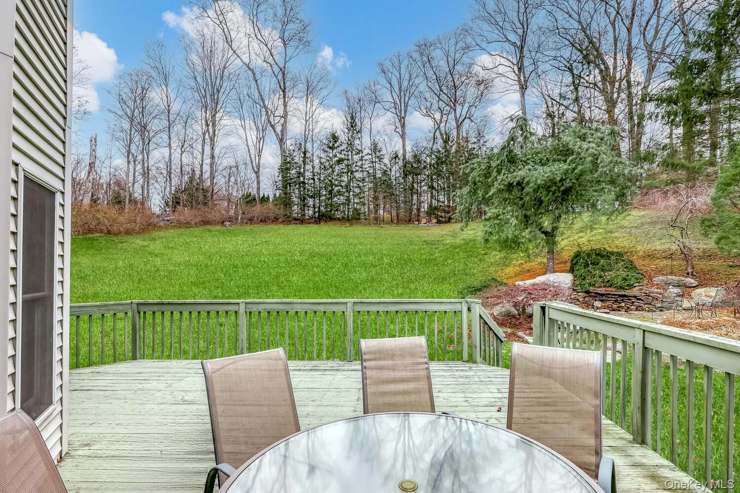 Deck featuring outdoor dining space and a lawn Deck featuring outdoor dining space and a lawn