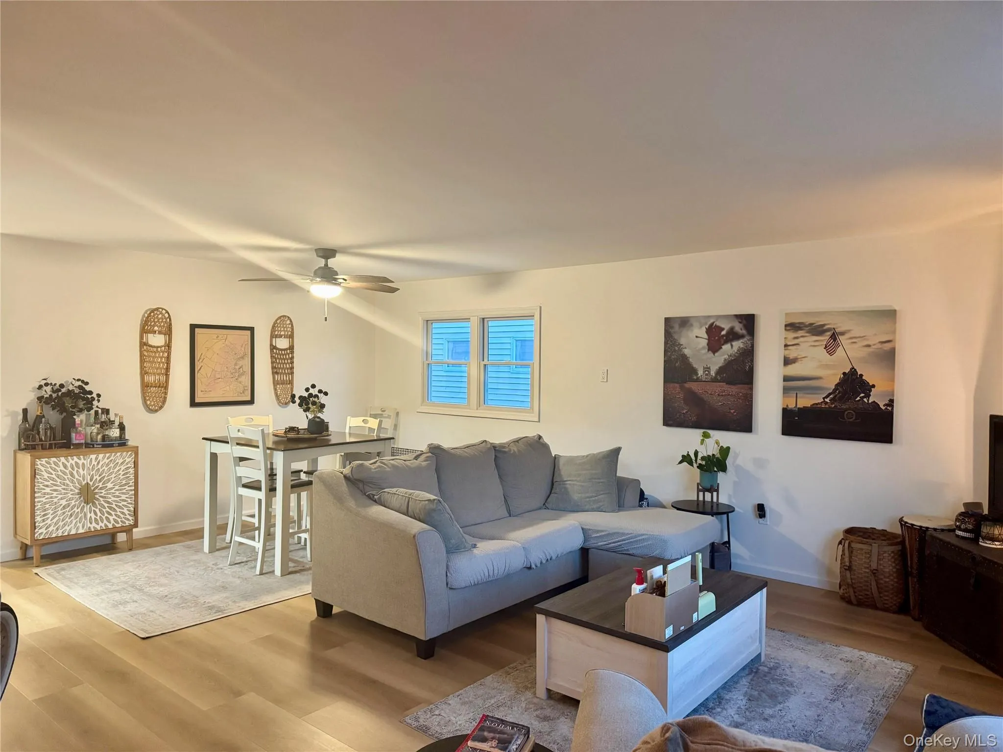 Living area featuring wood finished floors and ceiling fan Living area featuring wood finished floors and ceiling fan