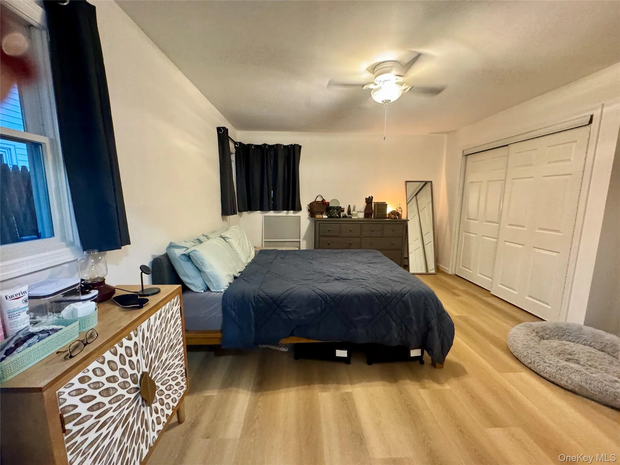 Bedroom featuring light wood-style flooring, a closet, and ceiling fan Bedroom featuring light wood-style flooring, a closet, and ceiling fan