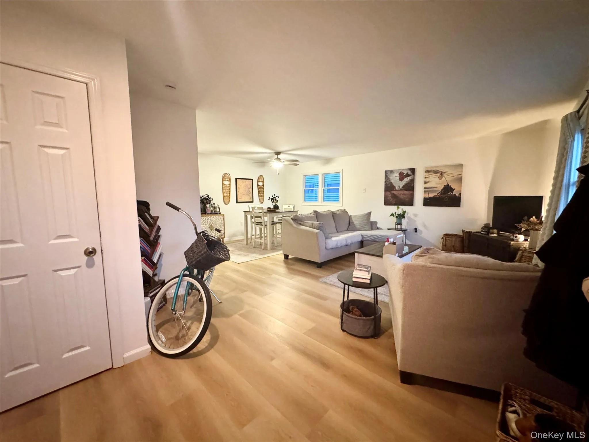 Living area with light wood-type flooring and a ceiling fan Living area with light wood-type flooring and a ceiling fan