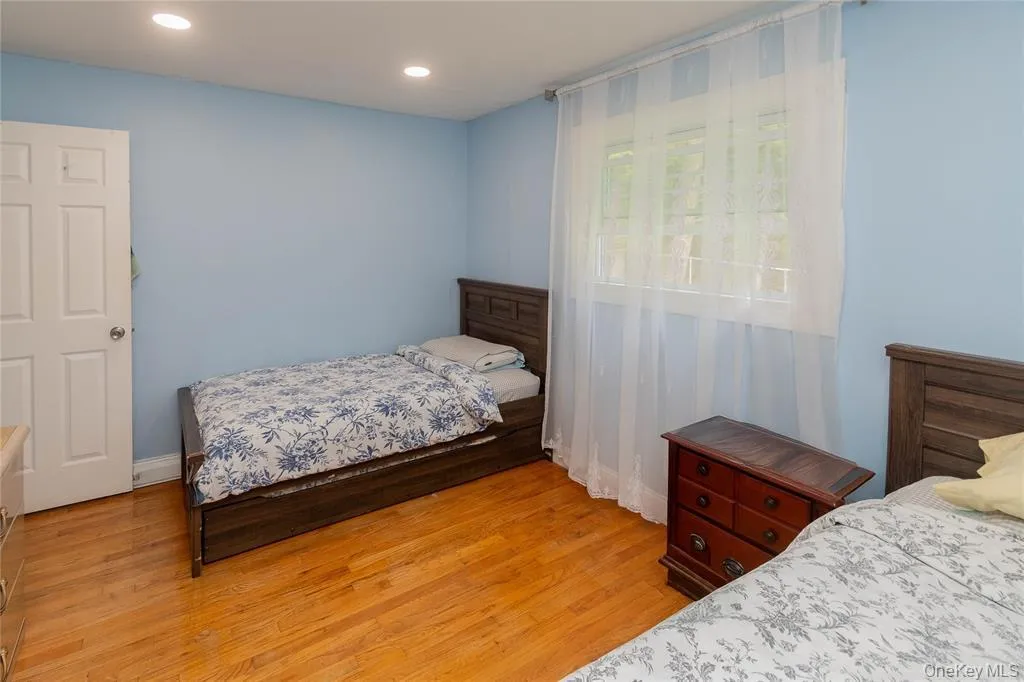 Bedroom with light wood-type flooring and recessed lighting Bedroom with light wood-type flooring and recessed lighting