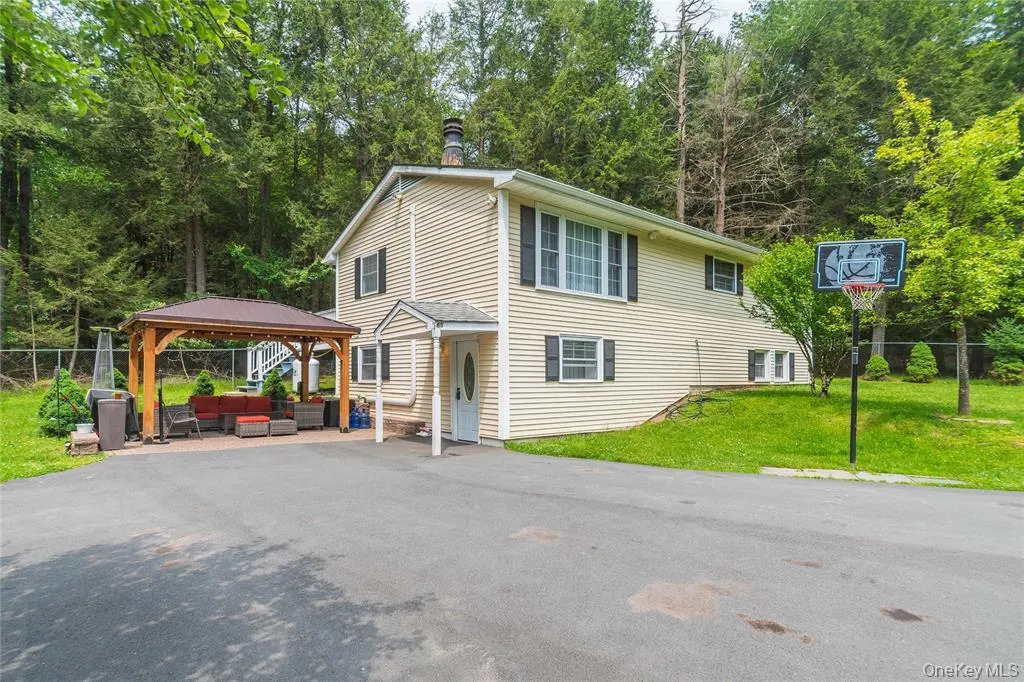 View of front of property with a gazebo, an outdoor living space, and a patio View of front of property with a gazebo, an outdoor living space, and a patio