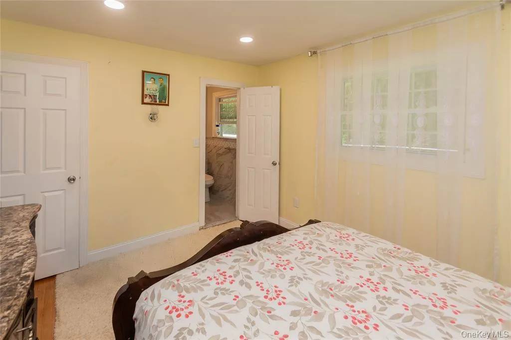 Bedroom with recessed lighting, carpet, and ensuite bathroom Bedroom with recessed lighting, carpet, and ensuite bathroom