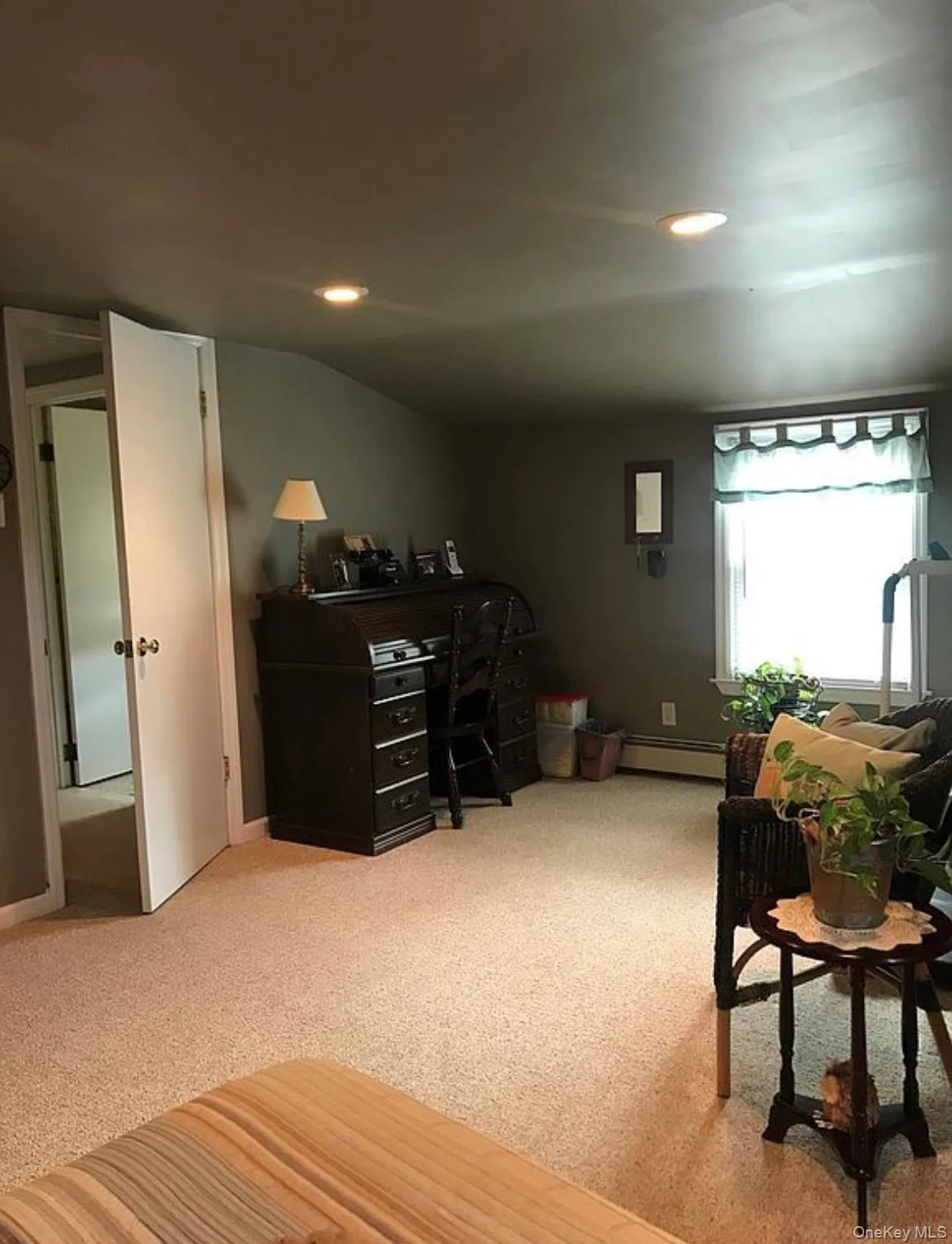 Office area featuring recessed lighting, light colored carpet, and a baseboard radiator Office area featuring recessed lighting, light colored carpet, and a baseboard radiator